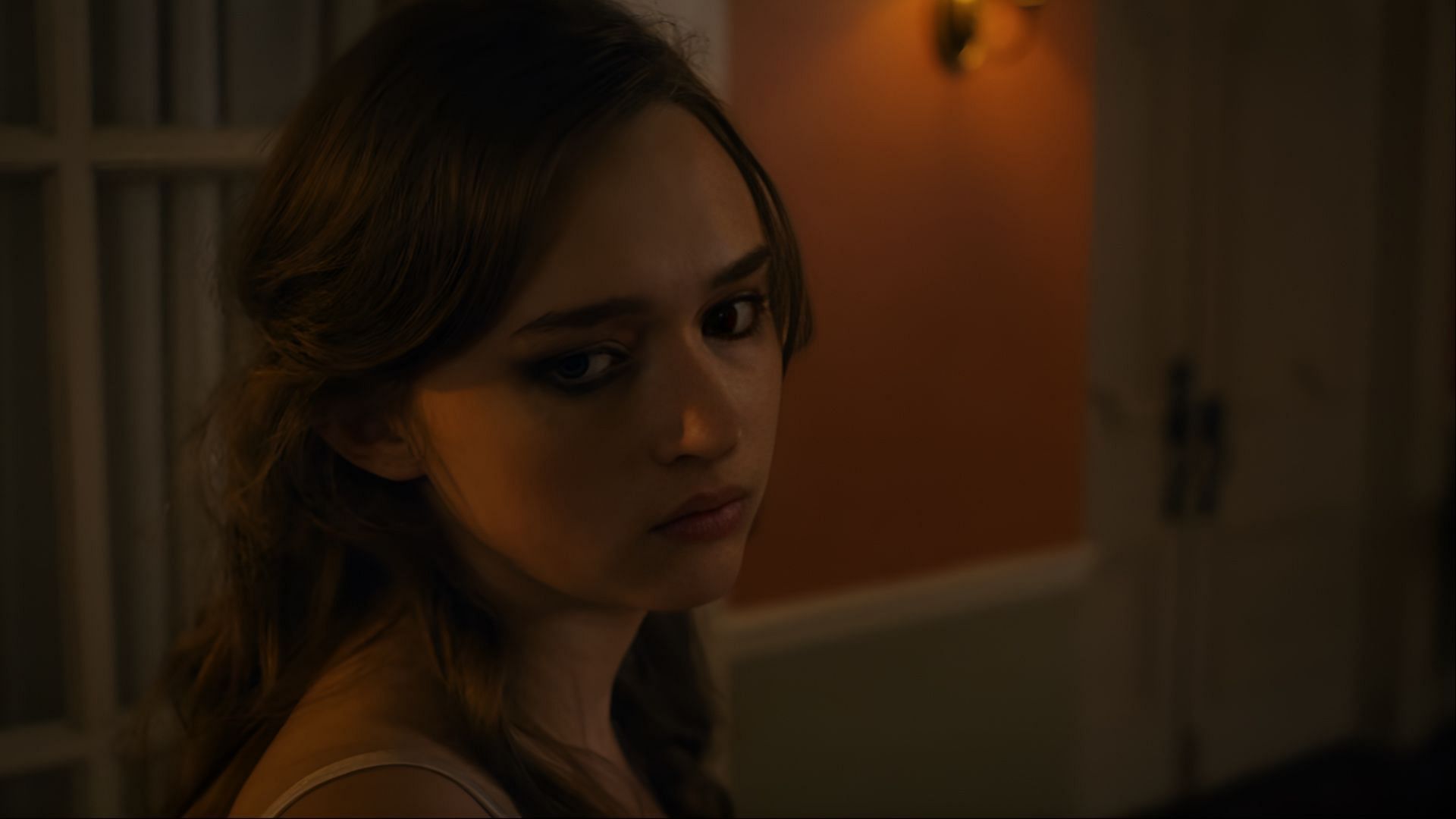 Lori Granger leaves the Falconer house after striking Nancy with a trophy, marking her final moment of survival and defiance in Fear Street: Prom Queen (Image via Netflix)